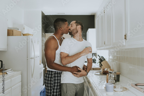 Couple kissing in kitchen photo