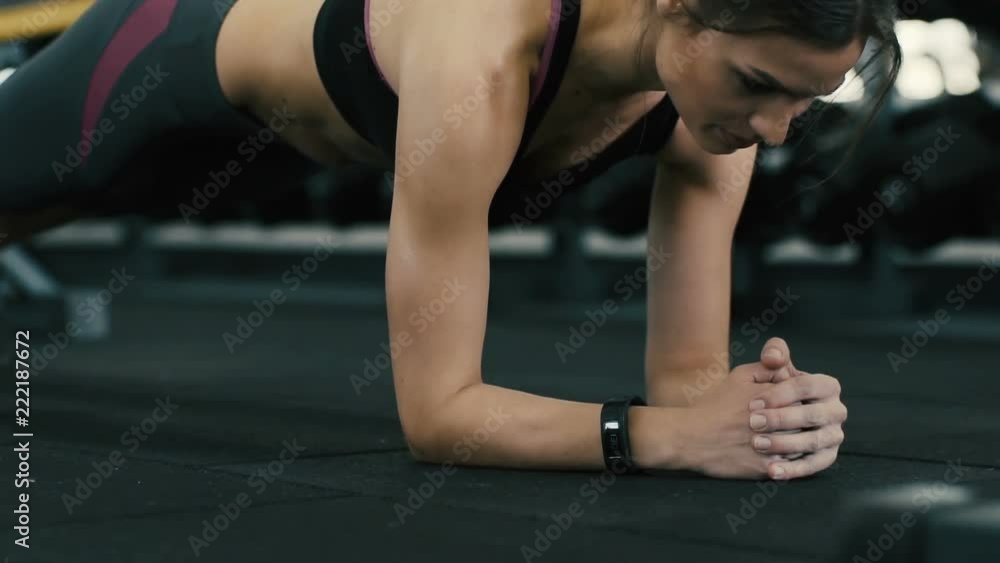 Fit attractive girl doing plank in gym Fit attractive girl doing plank in gym