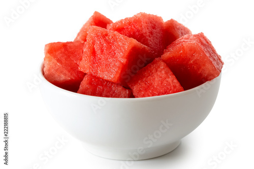Seedless watermelon cubes in white ceramic bowl isolated on white.