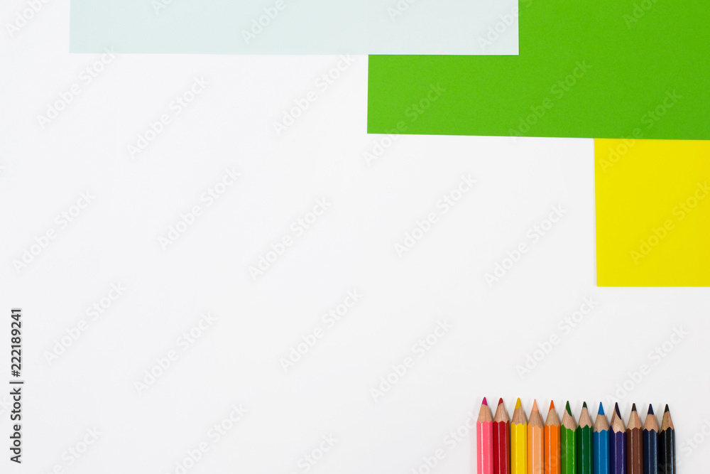 Color pencils isolated on white background with colored pieces. Place for text, minimal style, top view