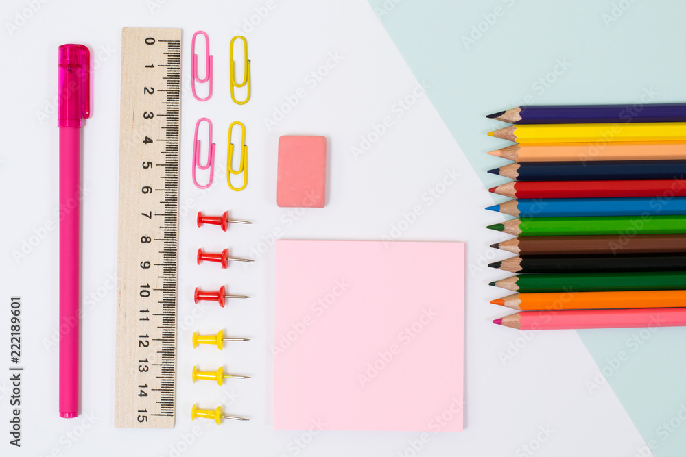 School supplies. Top view photo of stickers, paper clips and pins, ruler, rubber on white background School supplies. Top view photo of stickers, paper clips and pins, ruler, rubber on white background