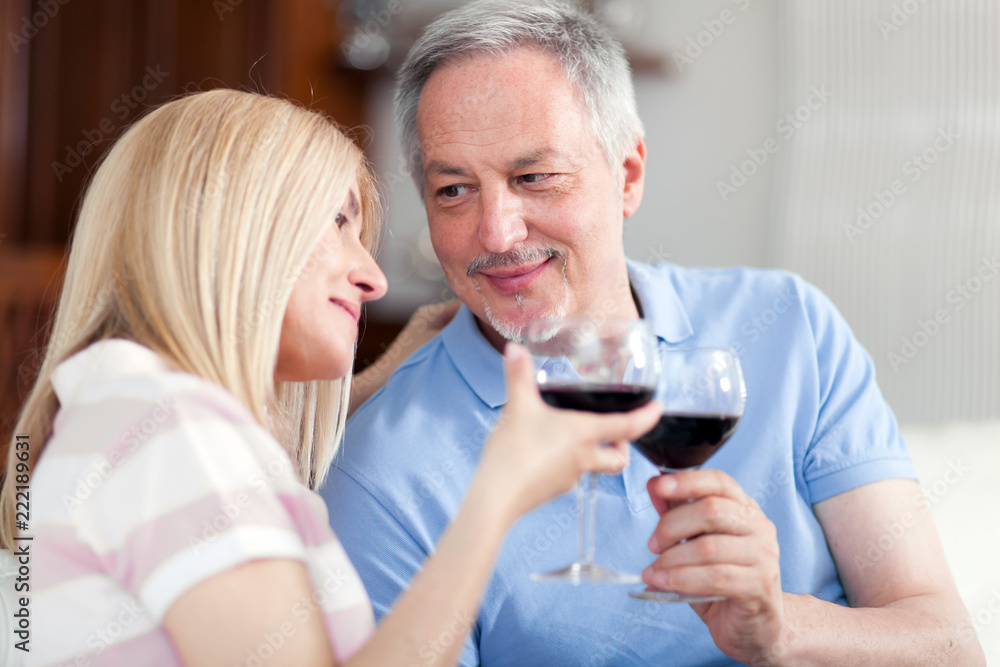 Mature couple toasting wine glasses Mature couple toasting wine glasses