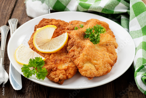 Canvas Print Homemade breaded german weiner schnitzel with potatoes. top view