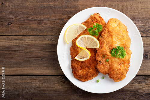 Tableau sur toile Homemade breaded german weiner schnitzel with potatoes. top view