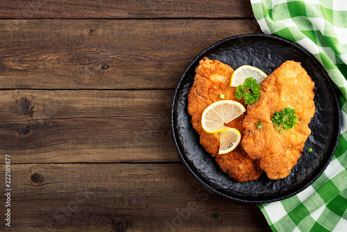 Homemade breaded german weiner schnitzel with potatoes. top view photo