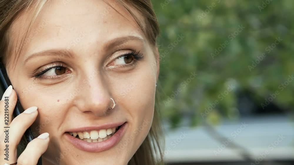 Young woman with piercing talking on the phone Young woman with piercing talking on the phone