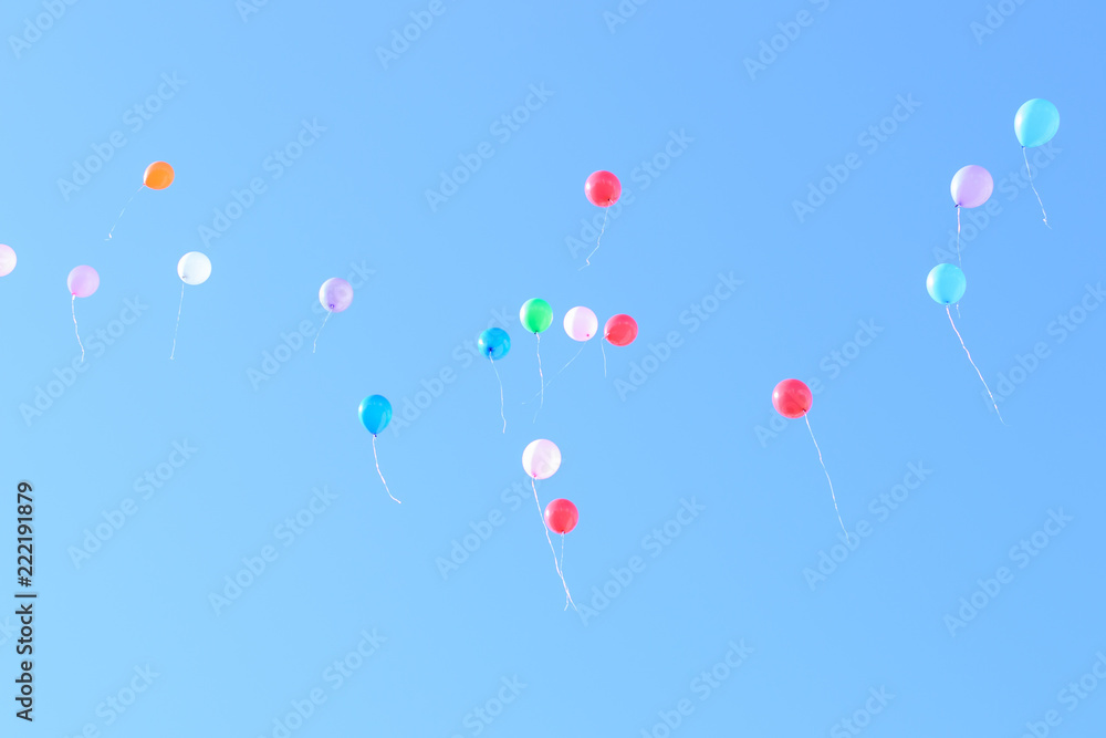 Many colorful ballons in the blue and clear sky. Concept of celebration
