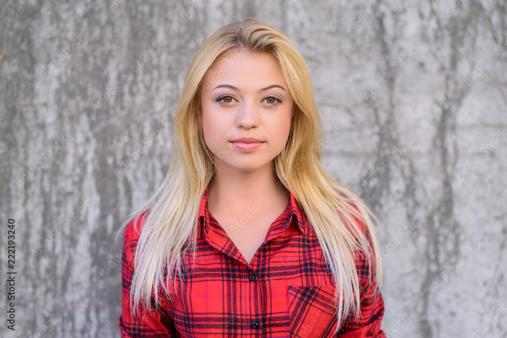 Fototapeta premium Close up photo of young girl with clean skin, good hair and perfect natural make up. She is looking at camera. Isolated on grey background