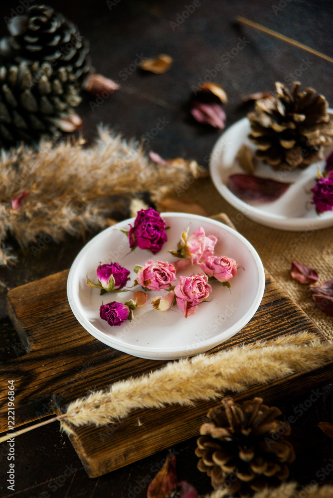 Flower tea: tea rose, petals, edible flowers, on a light background Flower tea: tea rose, petals, edible flowers, on a light background
