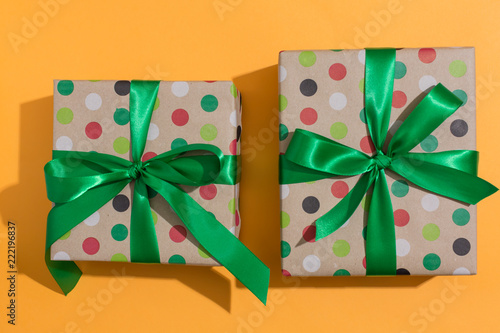 Two gift boxes on a orange background