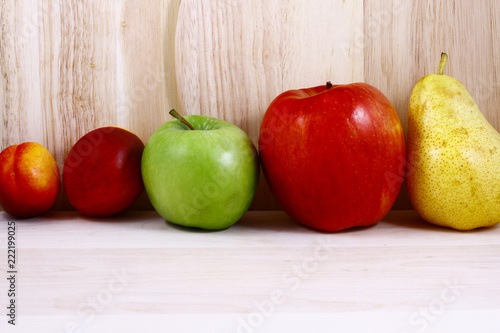 Beautifully laid out fresh summer fruits on a background of cutting boards photo