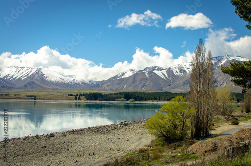 Lake in New Zealand with snowy mountains in the background