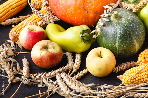 Thanksgiving Day concept - border or frame with orange pumpkins and colourful leaves on wooden background photo