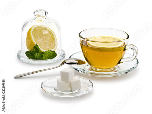 Green tea, lemon, mint and sugar in glassware