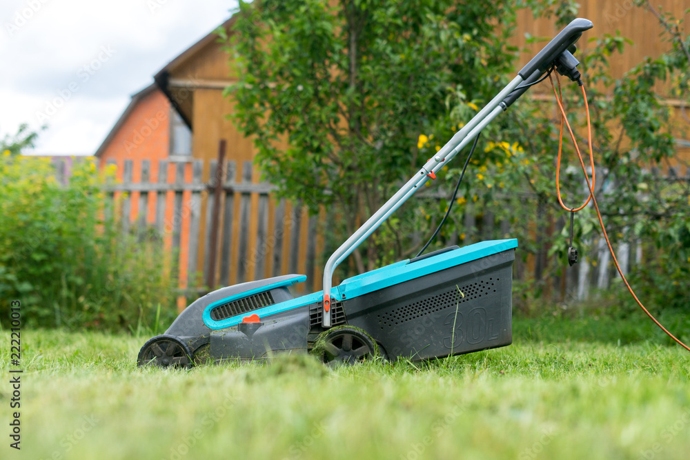 Fototapeta premium outdoor worker mowing the lawn