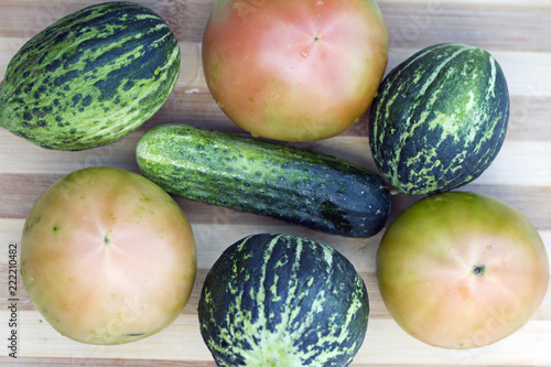 Organic tomatoes, fresh cucumber and unripe watermelon photo