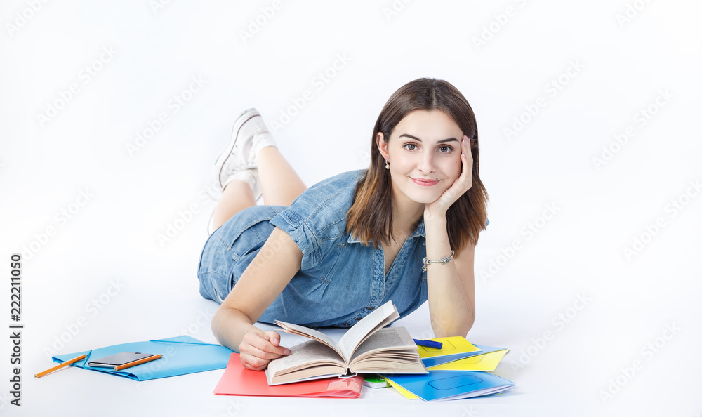 Young girl student teenager studying with copybooks, textbook pen  and smartphone