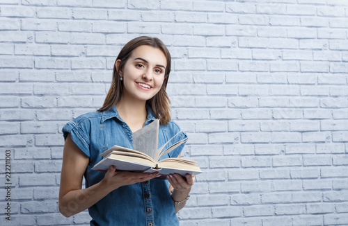 Young girl student teenager studying  reading a book