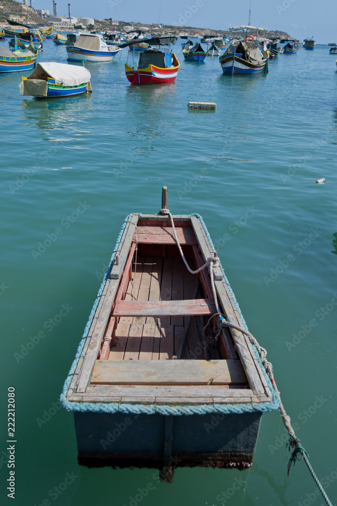Traditional colorful boats in the Harbor of Mediterranean fishing village Marsaxlokk, Malta