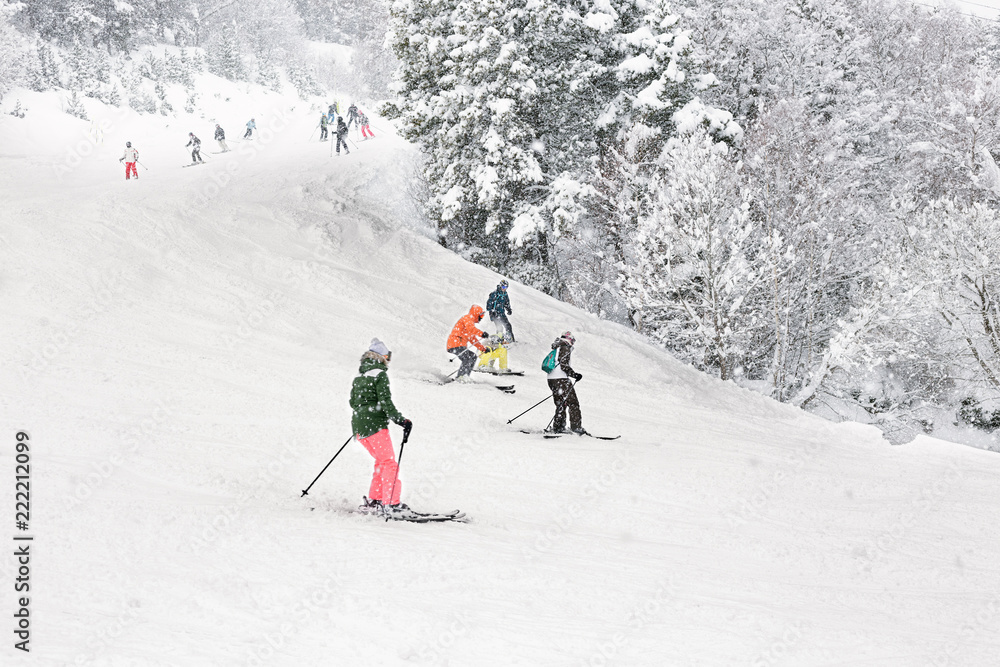 Downhill skiing during a heavy snowfall.