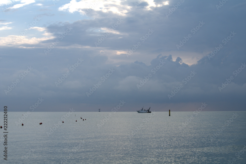 fishing boat in sea at sunset,horizon,boat,clouds,calm