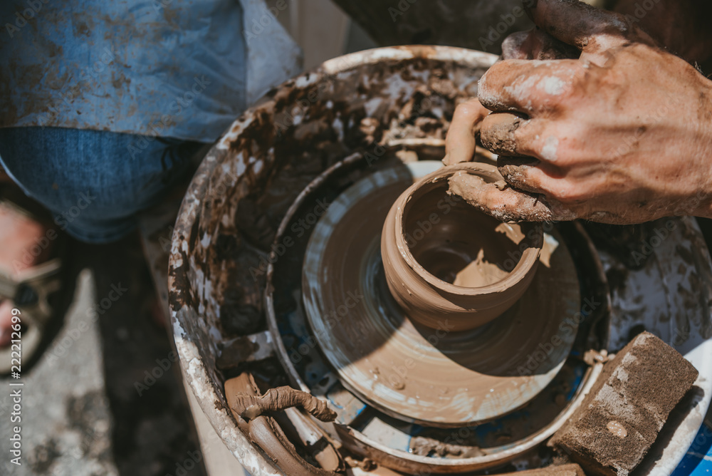 Master hands makes a pot of clay. Master class is held in nature, close-up Master hands makes a pot of clay. Master class is held in nature, close-up
