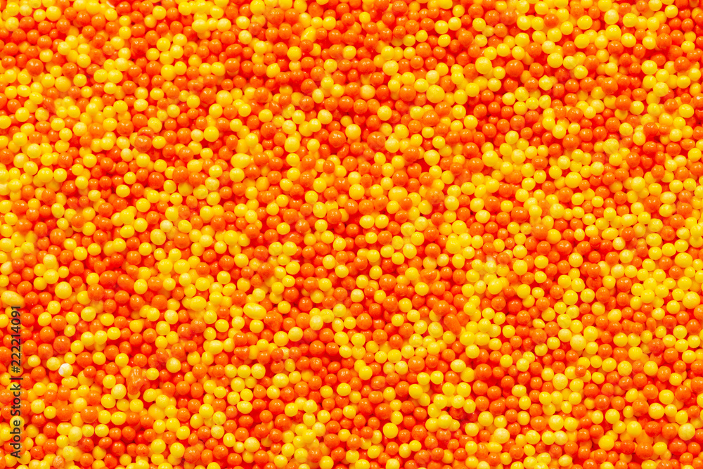 Fototapeta premium Orange and yellow candy sprinkles macro background