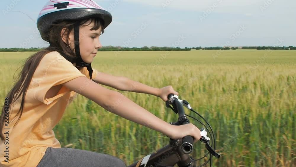 Child on a bicycle. Little girl on a bike outside the city. Child on a bicycle. Little girl on a bike outside the city.