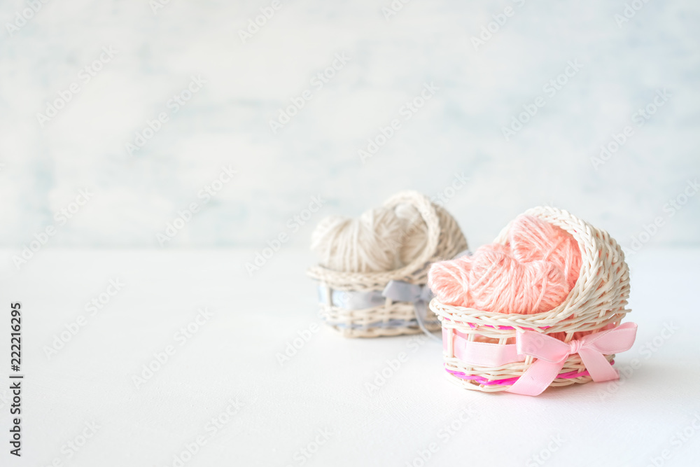 Obraz premium Pink and blue decorative straw cradles with thread hearts. Baby shower ideas, birthday, girl and boy, party, newborn