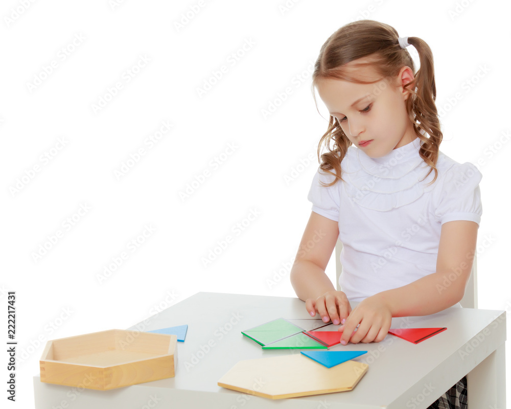A little girl is studying Montessori stuff. A little girl is studying Montessori stuff.