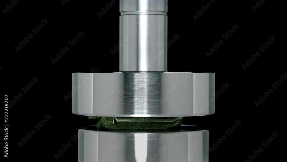 the toy tank is crushed by a hydraulic press, close-up the toy tank is crushed by a hydraulic press, close-up