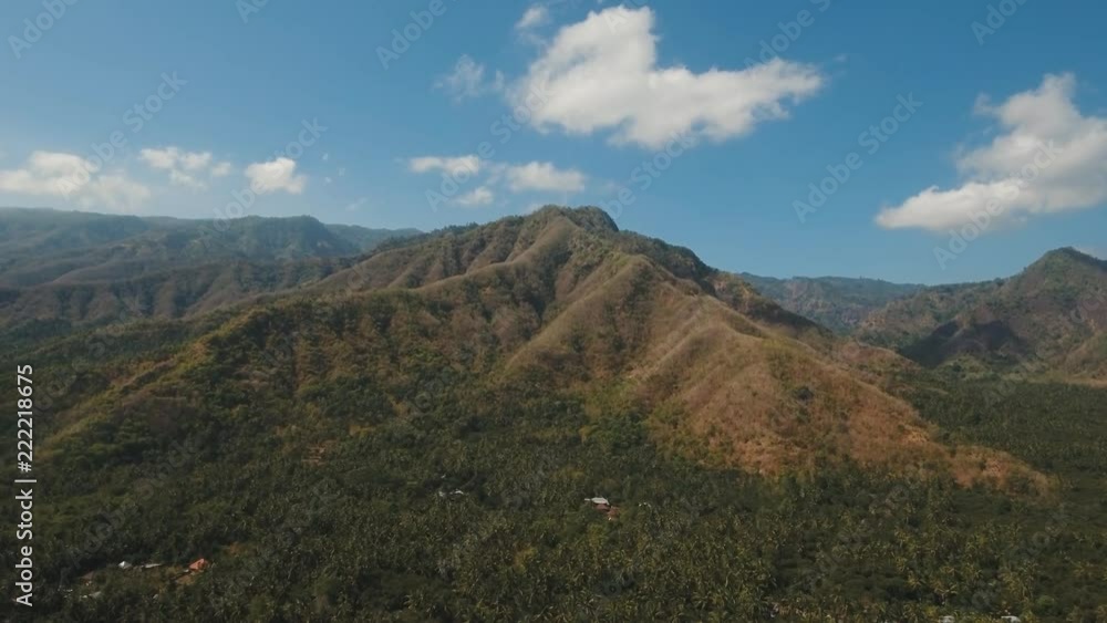 Aerial view of landscape, mountains covered with green forest, trees with sky and clouds, Bali,Indonesia. Slopes of the mountains are covered with forest in Asia. 4K video. Travel concept. Aerial Aerial view of landscape, mountains covered with green forest, trees with sky and clouds, Bali,Indonesia. Slopes of the mountains are covered with forest in Asia. 4K video. Travel concept. Aerial