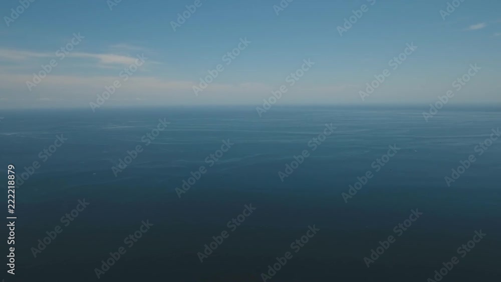 Aerial view: Sea water surface with waves. Flying over the blue ocean with blue water, sky, clouds. Bali,Indonesia.4K video. Travel concept. Aerial footage Aerial view: Sea water surface with waves. Flying over the blue ocean with blue water, sky, clouds. Bali,Indonesia.4K video. Travel concept. Aerial footage