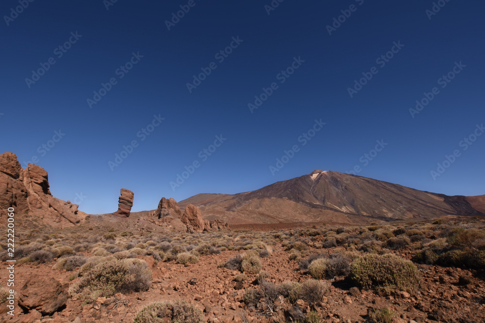 View of beautiful volcano Teide with rock formation Los Roques de Garcia in front in Tenerife, Canary Islands, Spain