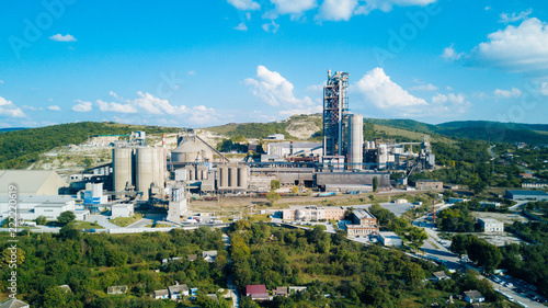 Aerial view of cement manufacturing plant. Concept of buildings at the factory, steel pipes, giants.