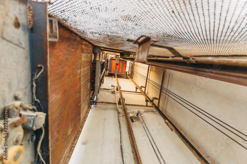 Fotografie Old freight elevator shaft. View up