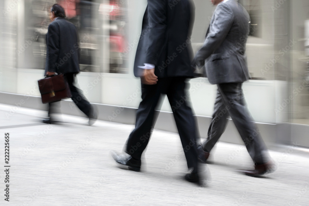 motion blurred business people walking on the street motion blurred business people walking on the street