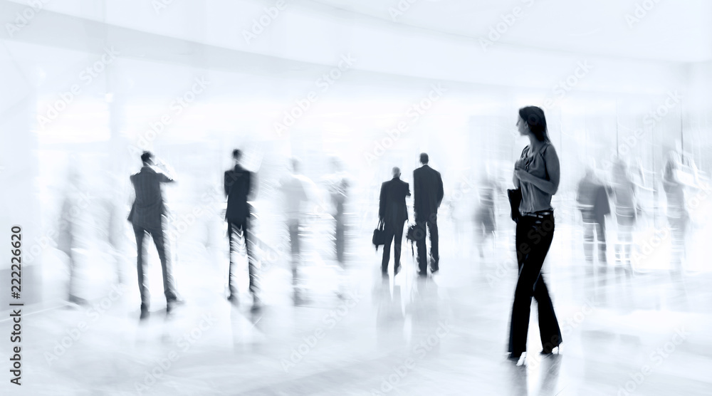 abstrakt image of people in the lobby of a modern business center with a blurred background and blue tonality abstrakt image of people in the lobby of a modern business center with a blurred background and blue tonality