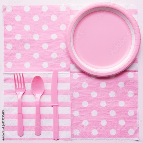 Pink color paper plate with plastic spoon, fork and knife for children party design