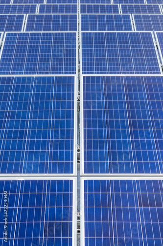 Close up rows array of polycrystalline silicon solar cells or photovoltaics in solar power plant turn up skyward absorb the sunlight from the sun use light energy to generate electricity 