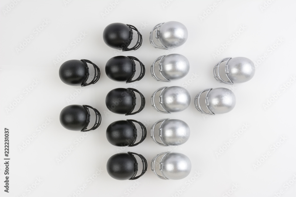Football helmets lined up facing each other in play formation Football helmets lined up facing each other in play formation
