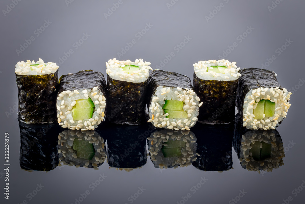 cucumber maki on black background with reflection cucumber maki on black background with reflection