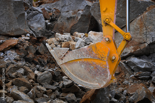 excavator bucket full of rocks