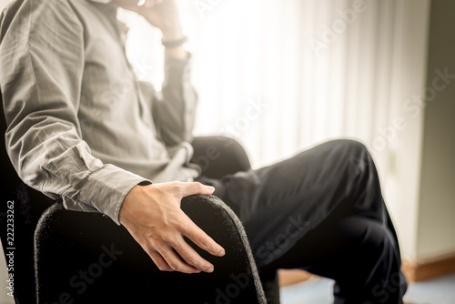 Close up Business Man Hands Sitting on Black Chair in Office Room