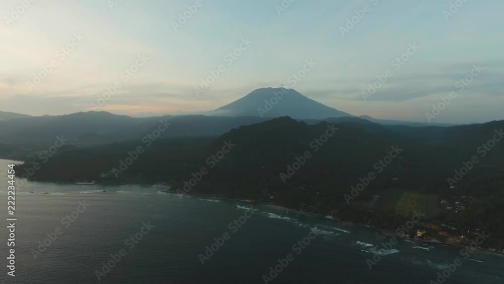 Aerial view of Sunset over the sea,mountains, Agung volcano, coast, beach, sky, clouds. Bali, Indonesia. Sunset on the island of Bali. Aerial footage Aerial view of Sunset over the sea,mountains, Agung volcano, coast, beach, sky, clouds. Bali, Indonesia. Sunset on the island of Bali. Aerial footage