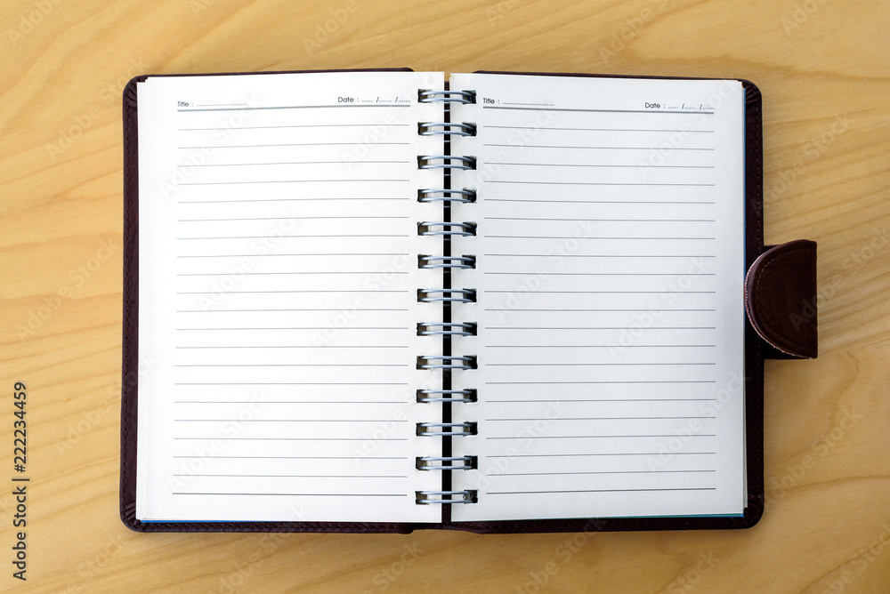 Open blank Notebook with white lined pages on Wooden Table background Open blank Notebook with white lined pages on Wooden Table background