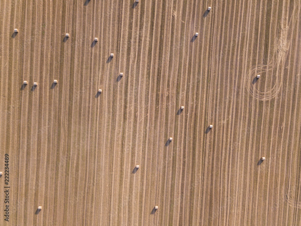 Aerial: stubble field with straw bales at late summer Aerial: stubble field with straw bales at late summer