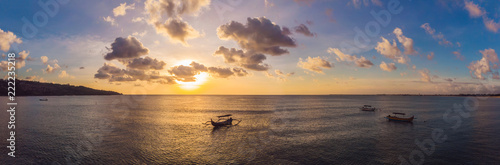 Traditional Balinese boat Jukung at Jimbaran beach at sunset in Bali, Indonesia Photo from the drone photo