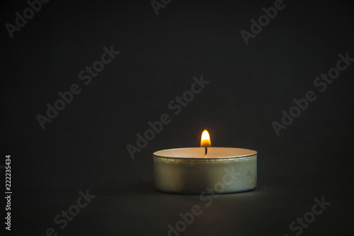background of sorrows lonely candle on a dark black texture