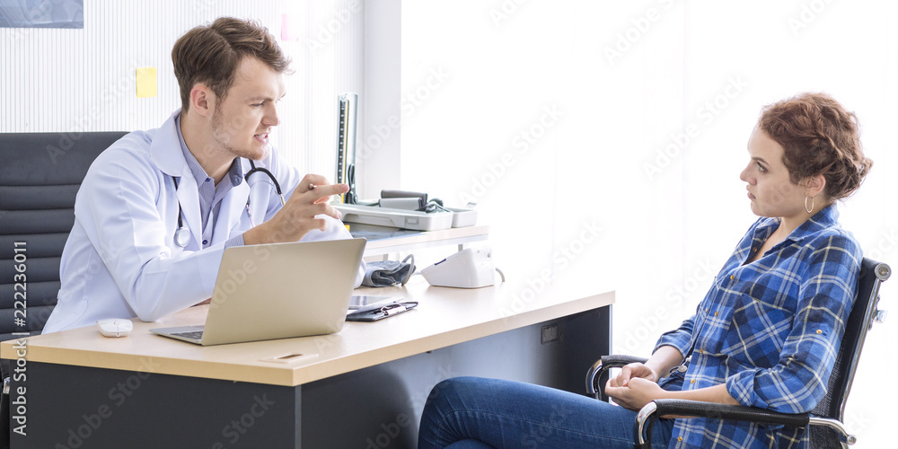 Medical professionals caucasian man reassuring and talking with young woman stress patient.Close up and copy space. Medical professionals caucasian man reassuring and talking with young woman stress patient.Close up and copy space.